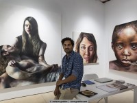 the painter johan andersson in front of his artworks
